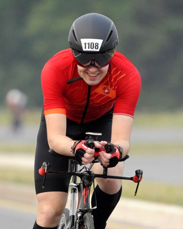 Victor smiling on his time-trial bike at IRONMAN Ottawa.